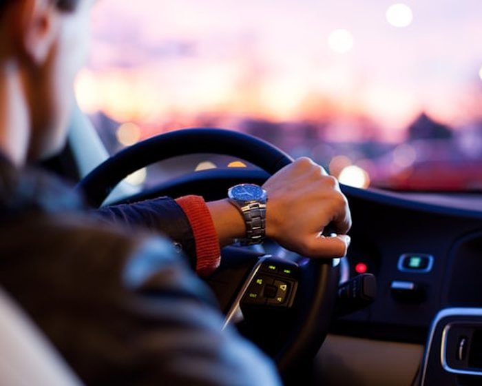 A BTT Travels driver at the wheel on an early-morning city run