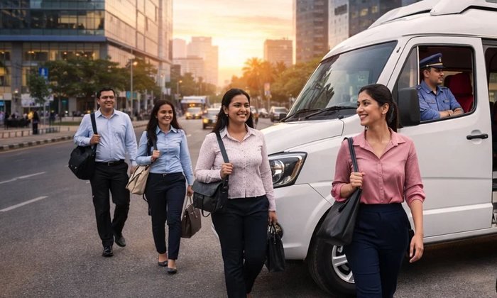 Office staff walking from a BTT Travels shuttle in the city at sunset
